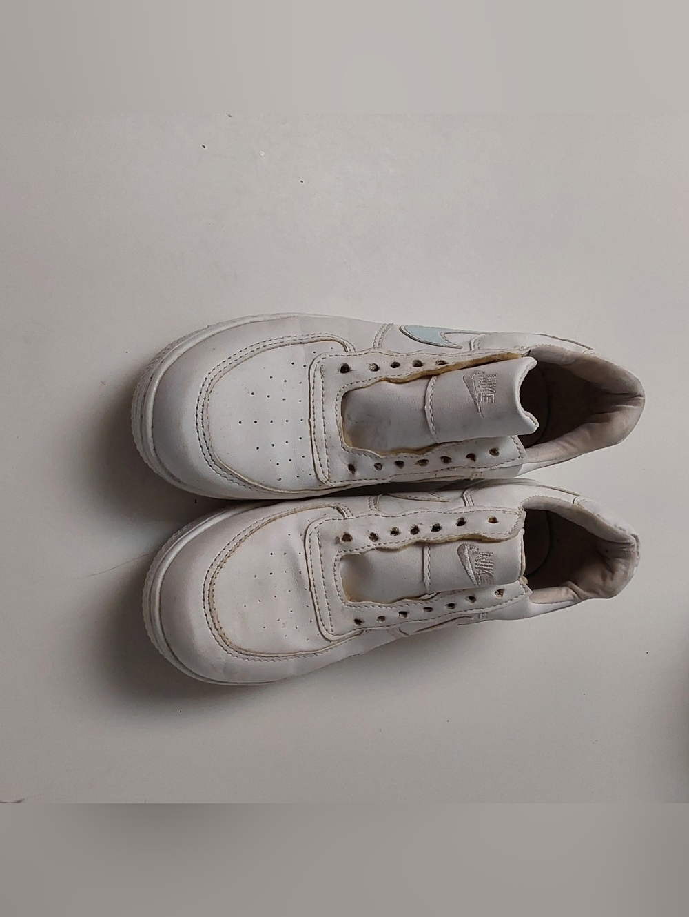White Nike Air Force 1 Sneakers with Subtle Blue Swoosh